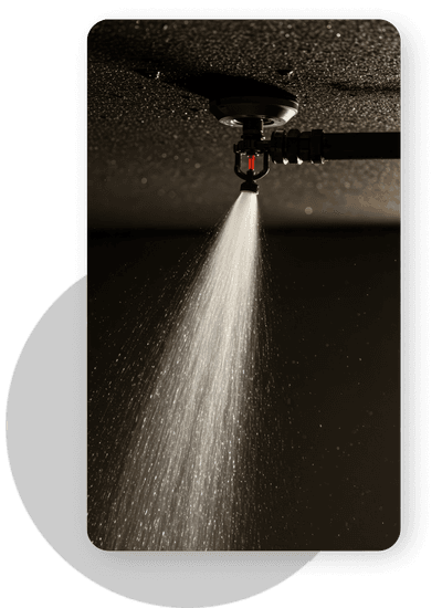Fire sprinkler water spraying from ceiling sprinkler